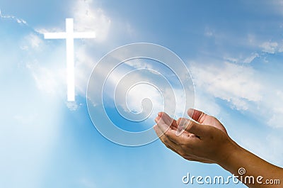 Pray for God`s blessing Cross on natural background. Stock Photo