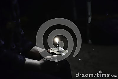 Pray while holding a candle Stock Photo