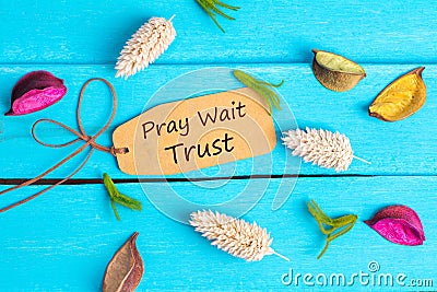 Pray wait trust text on paper tag Stock Photo