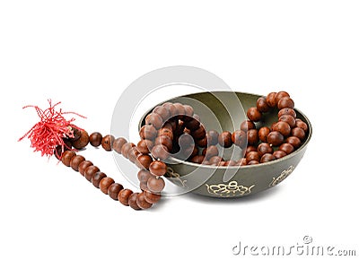 Prayer beads and copper singing bowl isolated on white background. Musical instrument for meditation, relaxation Stock Photo