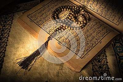 Prayer beads on Koran holy book of Muslims Stock Photo