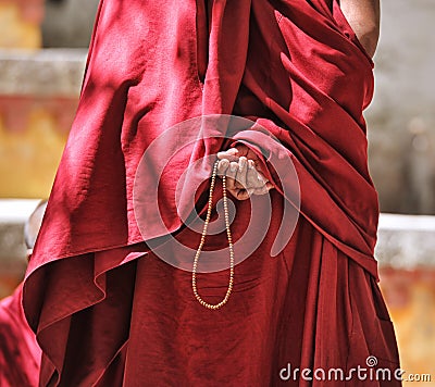 Prayer beads in monk's hand Stock Photo