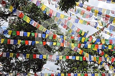 Prayer flags seen hanging ans flying in a hilly area in nepal Stock Photo