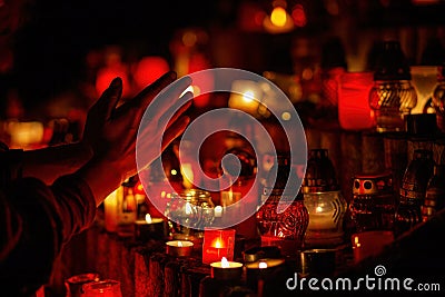 prayer hands. Candles in the cemetery. 1st November. Feast of All Saints. Hallowmas. All Souls& x27; Day. Stock Photo