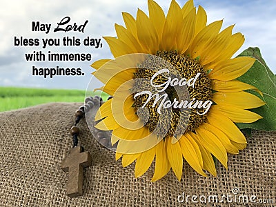 Prayer inspirational words - May Lord bless you this day, with immense happiness. Morning prayer quote with rosary and sunflower. Stock Photo