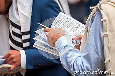 Prayer. The Jewish Hasid reads a religious book. Close-up of a book and hands. Holiday of Rosh Hashanah, Jewish New Year Editorial Stock Photo