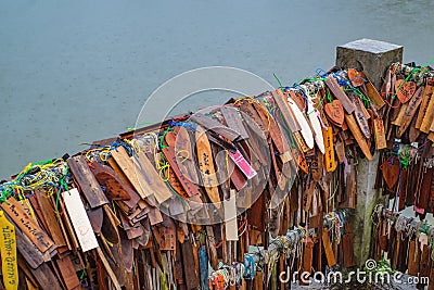 Prayer tags tied on the bridge in the Pilok mine village in kanchanaburi City Thailand. Editorial Stock Photo