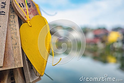 Prayer tags tied to a on the bridge in the Pilok mine village in kanchanaburi City Thailand. Stock Photo