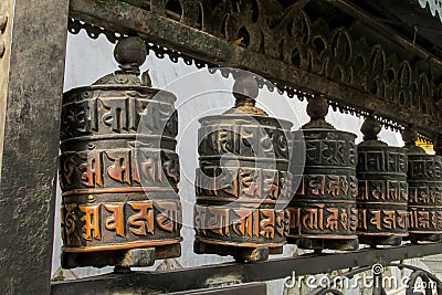 Prayer wheel in Nepali near the Buddhist temple Stock Photo