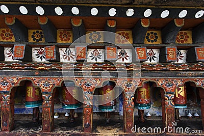 Prayer wheels in the Kyichu Lhakhang temple in Paro Valley, Bhutan Stock Photo