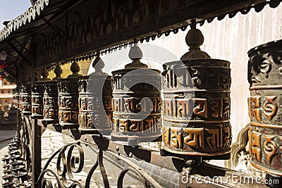 Prayer wheels made from metal at Swayambhunath Temple - Monkey Temple, Kathmandu, Nepal Stock Photo