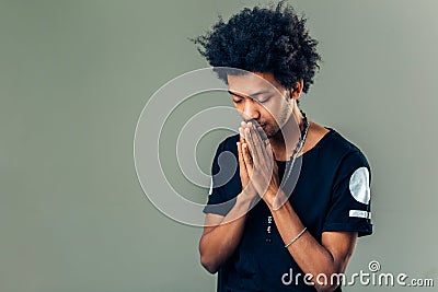 Praying african american man hoping for better. Asking God for good luck Stock Photo