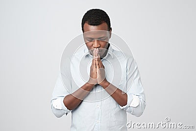 Praying african american man hoping for better. Stock Photo