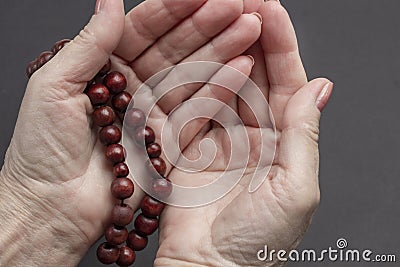 Praying female hands with rosary Stock Photo