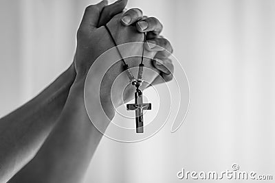 Praying hands holding a rosary. Stock Photo