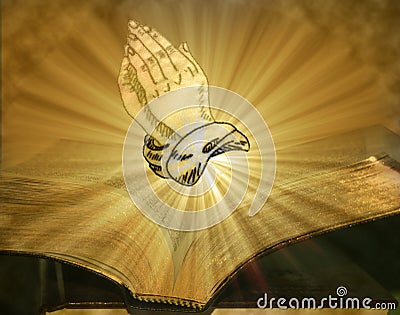 Praying Hands On Open Bible With Burst Of Light Stock Photo