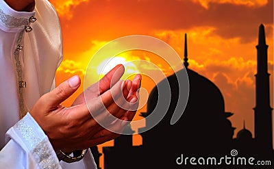 Praying hands with sunset background Stock Photo