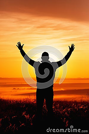 The praying man silhouette at sunrise Stock Photo