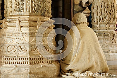 Praying monk insaid the Jain temple in India Stock Photo