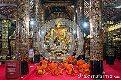 Praying Monks at Wat Xieng Thong luang prabang Editorial Stock Photo