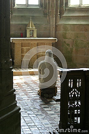 Praying nun in church Stock Photo