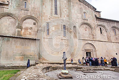 Praying people come inside the christian Svetitskhoveli Cathedral, built in 4th century. UNESCO World Heritage Site. Editorial Stock Photo