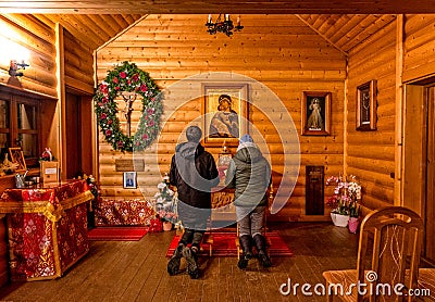 Praying people in front of the altar in the chapel Editorial Stock Photo