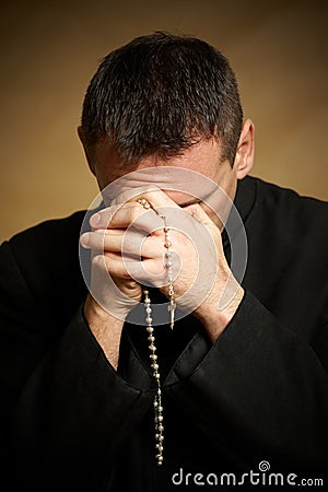 Praying priest Stock Photo