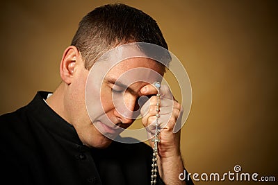 Praying priest Stock Photo