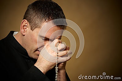 Praying priest Stock Photo