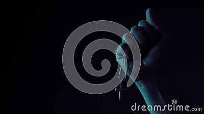 Praying with a rosary. hand of Catholic man with rosary on black background Stock Photo