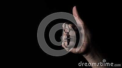 Praying with a rosary. hand of Catholic man with rosary on black background Stock Photo