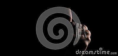 Praying with a rosary. hand of Catholic man with rosary on black background Stock Photo