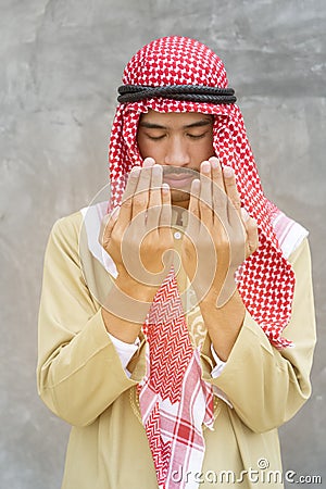 Praying to god with handsome arab man Stock Photo