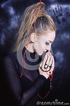 Praying woman with make-up in Gothic style Stock Photo