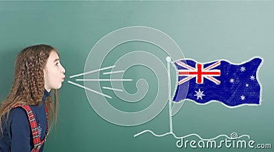 Pre-adolescent girl blowing on Australia flag Stock Photo