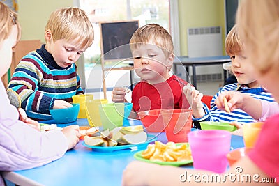 Pre School Children Eating Healthy Snacks At Breaktime Stock Photo