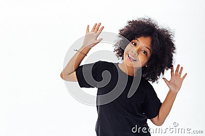 Pre-teen African American kid putting hands up being playful and happy Stock Photo