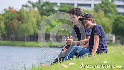 Pre wedding shooting : Lover sit near lagoon Stock Photo