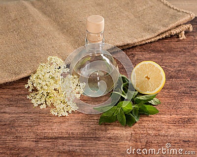 Preaparation for home made Elderberry syrup. Home made with sugar, and lemons. On the wooden background. Stock Photo