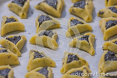 Prebaked `Haman pockets` also known as Hamantashen, an Ashkenazi Jewish triangular filled-pocket cookies Stock Photo