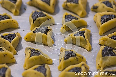 Prebaked `Haman pockets` also known as Hamantashen, an Ashkenazi Jewish triangular filled-pocket cookies Stock Photo