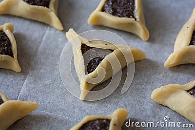 Prebaked `Haman pockets`, also known as Hamantashen, an Ashkenazi Jewish triangular filled-pocket cookies, usually associated with Stock Photo