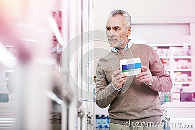 Precious purchaser comparing goods presented in a store Stock Photo