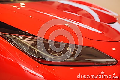 Predatory car headlight and hood of powerful sports car with matte paint. Stock Photo