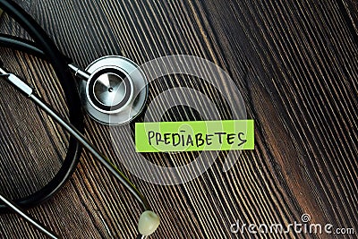 Prediabetes text on Sticky Notes. Top view isolated on Wooden Table. Healthcare/Medical concept Stock Photo