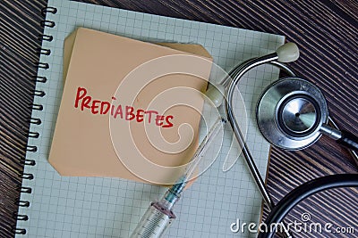Prediabetes write on sticky notes isolated on Wooden Table Stock Photo