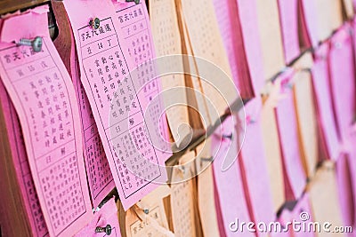 Predicted paper for answer of Fortune Sticks or Seam-si or Kau cim hanging on the wall in chinese temple, Bangkok, Thailand. Stock Photo