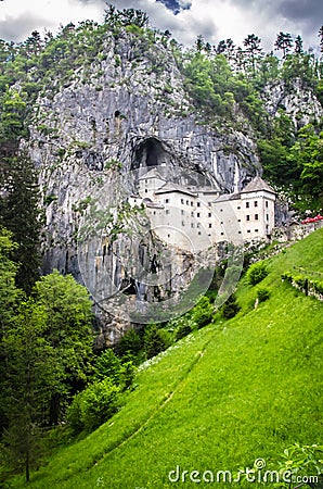 Predjamski Grad in the mouth of a cave . Stock Photo