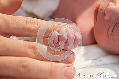 Preemie holding finger Stock Photo